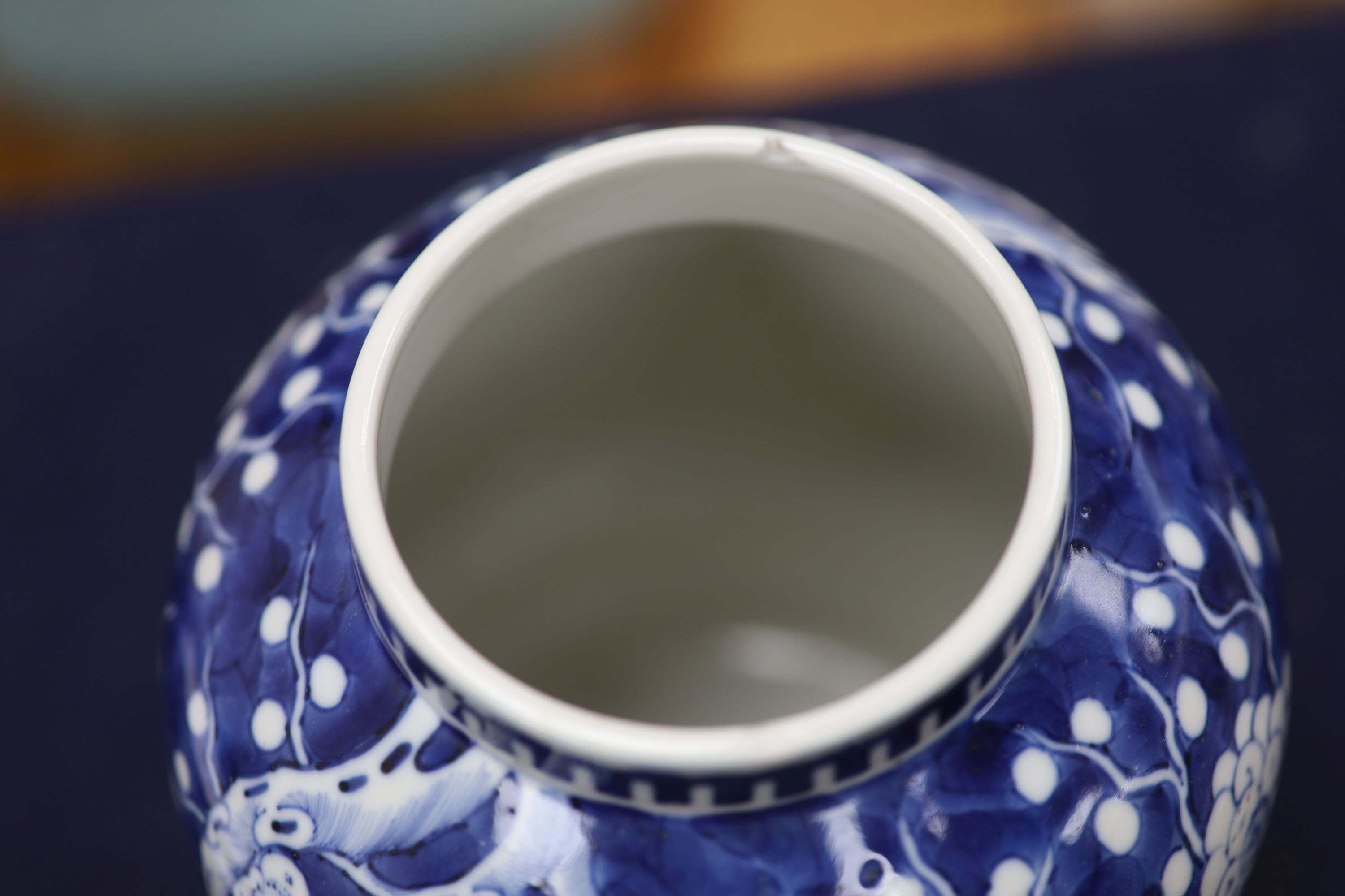 A 20th century Chinese blue and white jar and cover with prunus decoration, height 25cm